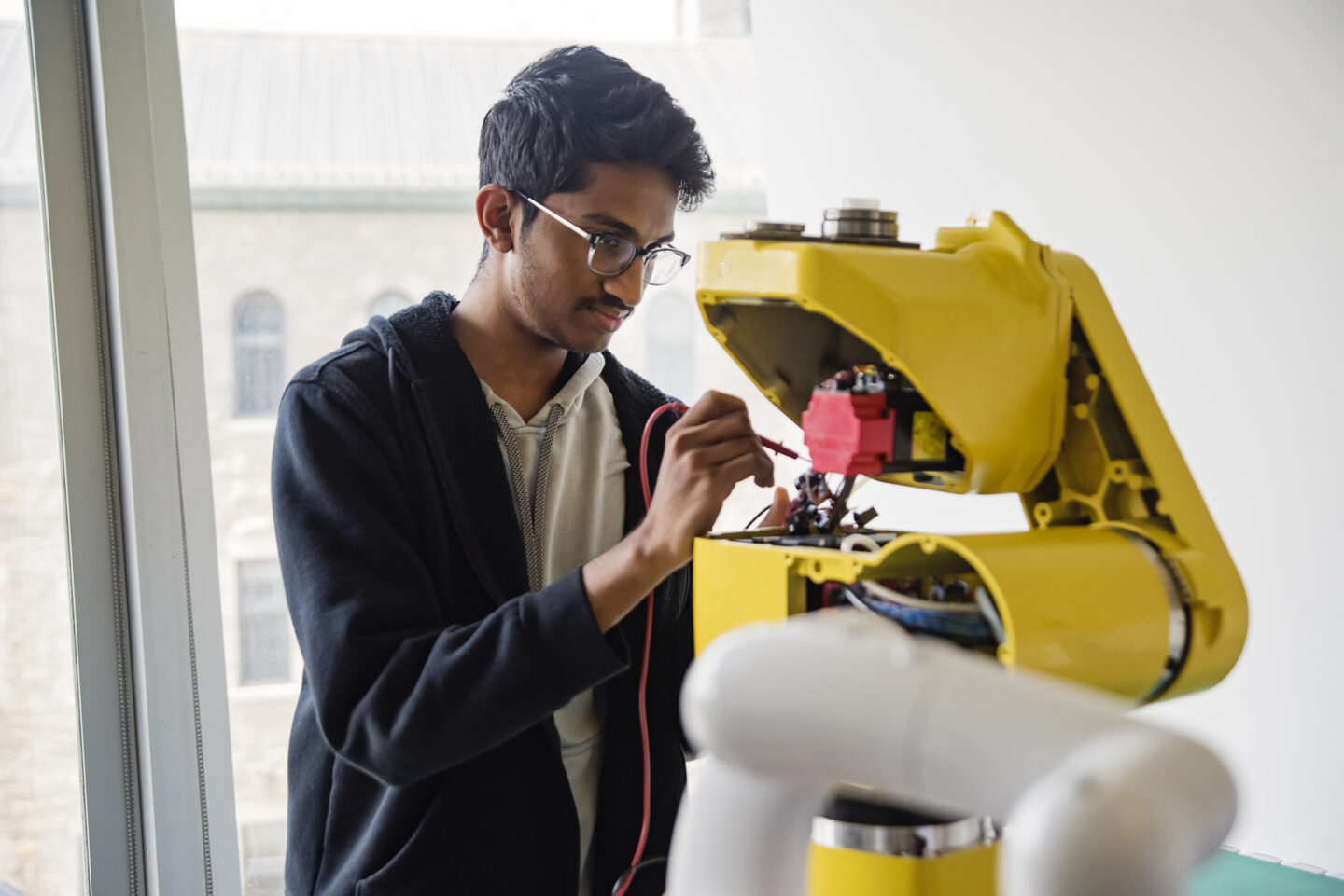 Een Indiase ingenieur werkt aan een robot in de Indiase technologiesector